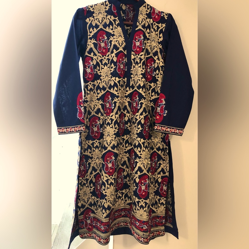 Pakistani luxury lawn Embroidered three piece dress.